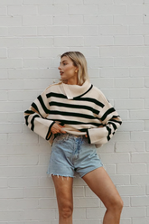 a lady in a striped sweater and a pair of jeans shorts